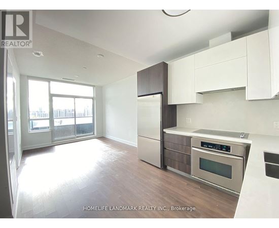A modern kitchen with white cabinets and stainless steel appliances.