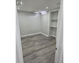 A room with a grey floor and white walls.