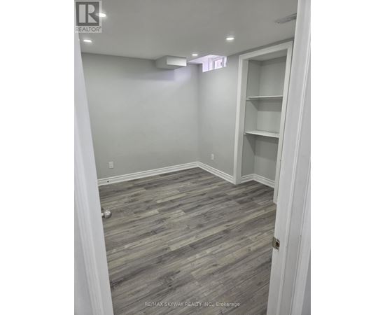 A room with a grey floor and white walls.
