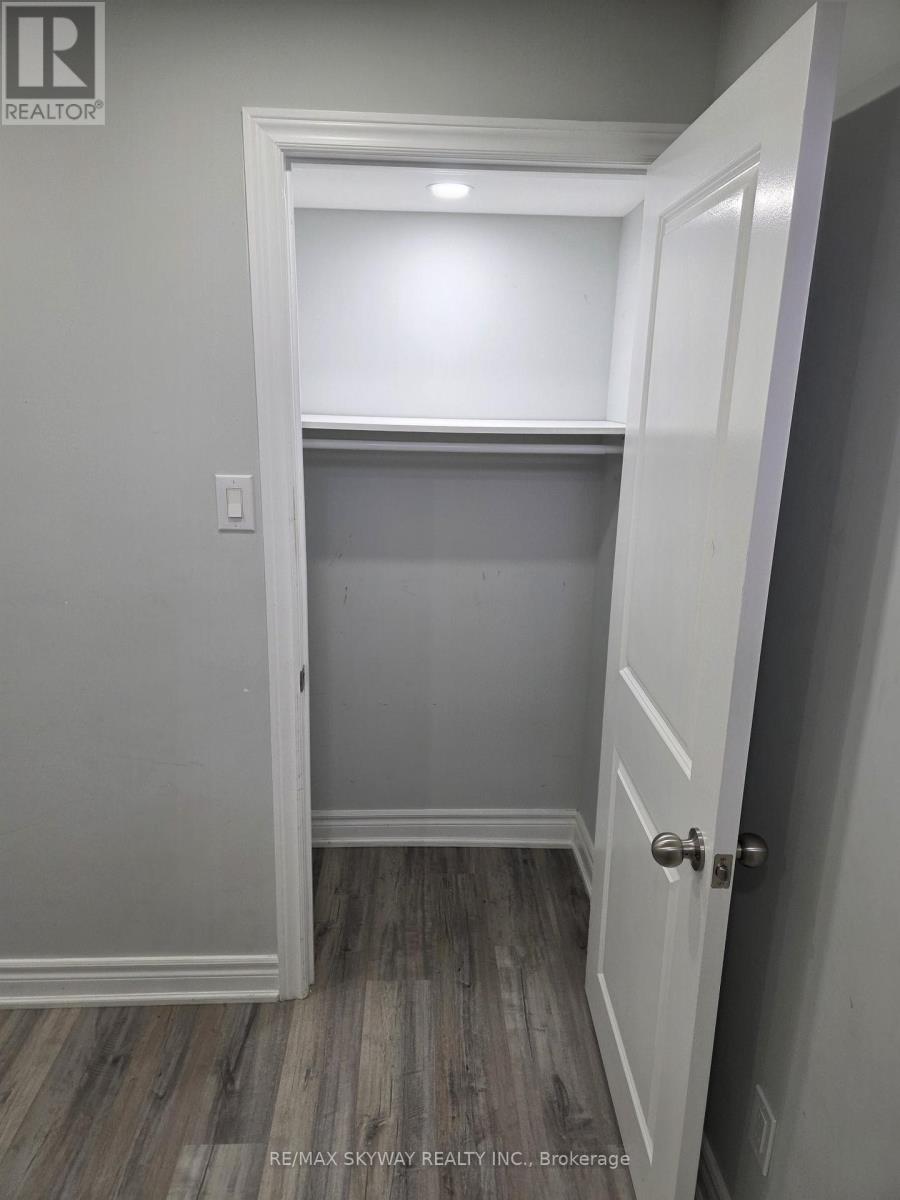 A white door is open to a room with grey walls.