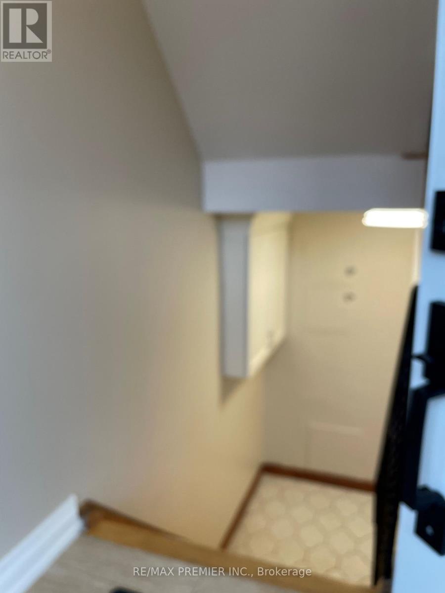 A hallway with a door and a tiled floor.