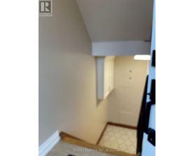 A hallway with a door and a tiled floor.