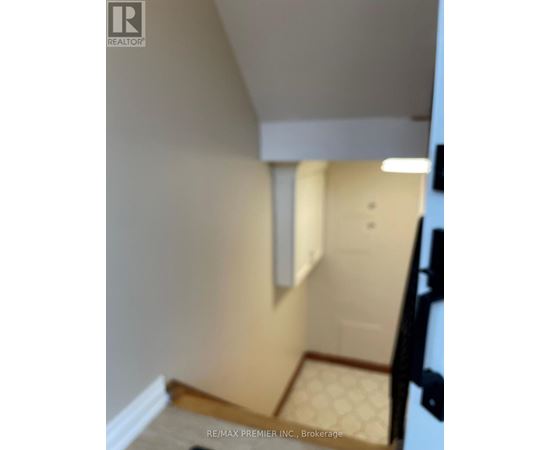 A hallway with a door and a tiled floor.