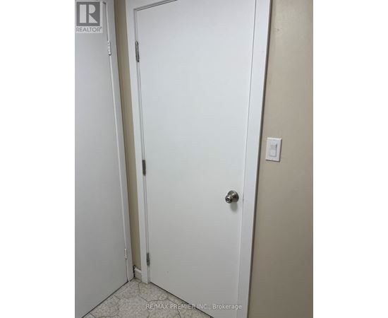 A white door with a silver handle in a room.