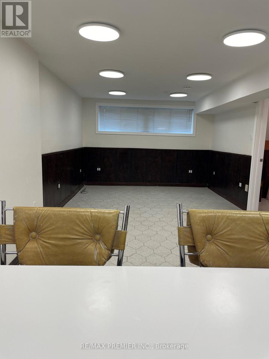 A conference room with a table, chairs and a window.
