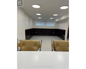 A conference room with a table, chairs and a window.
