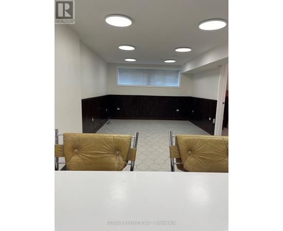 A conference room with a table, chairs and a window.