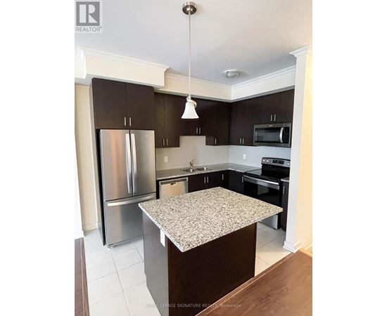 A kitchen with a granite counter top and stainless steel appliances.