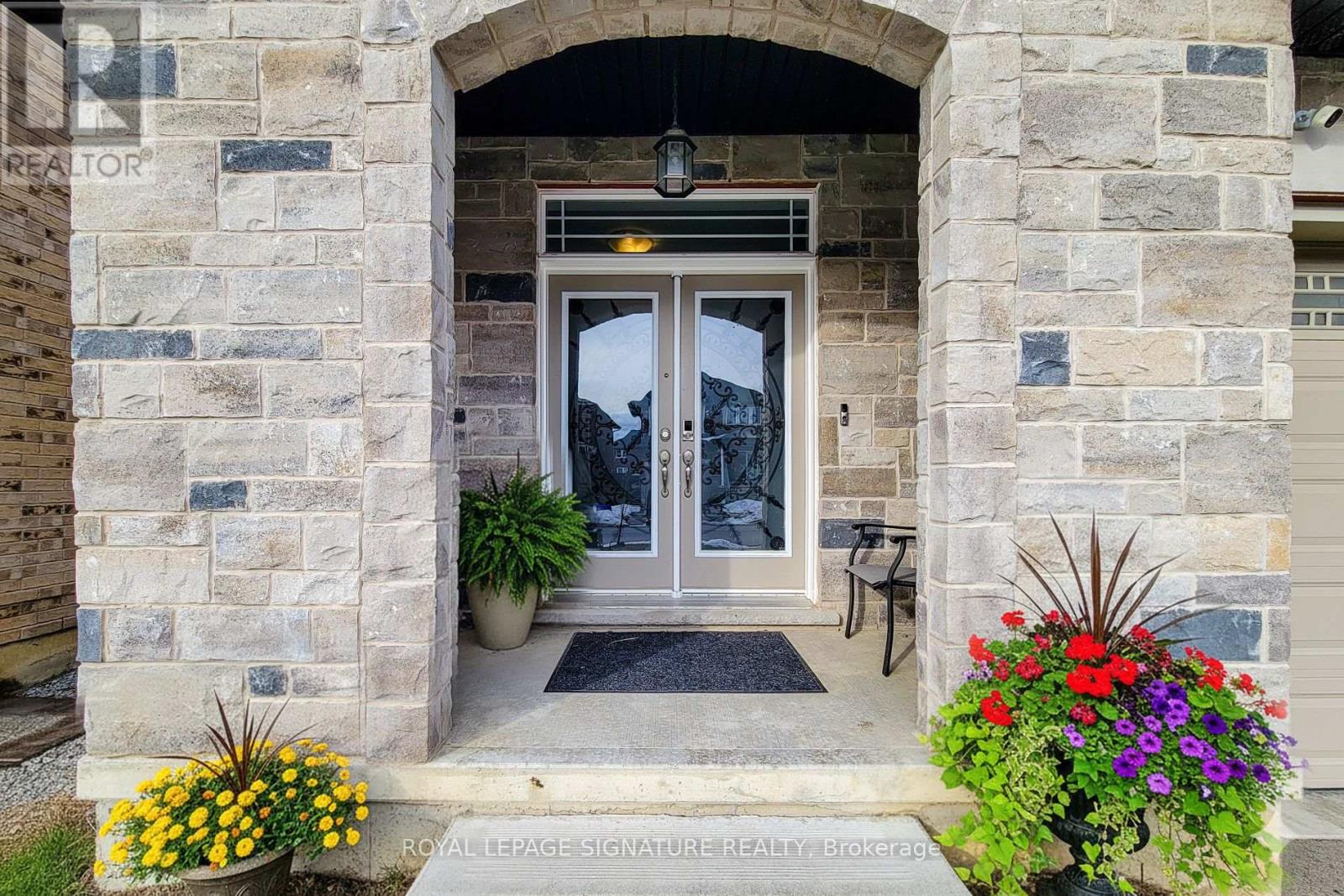 A stone building with a glass door and a sign that says Royal LePage Signature Realty Brokerage.