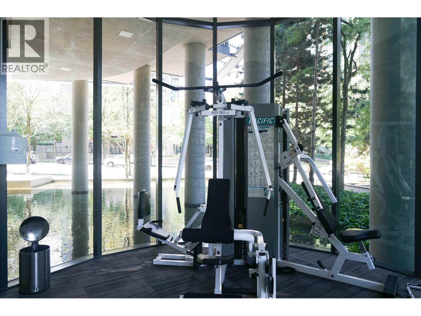 A gym with a weight machine and a bench.