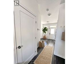 A hallway with a door on the left and a door on the right.