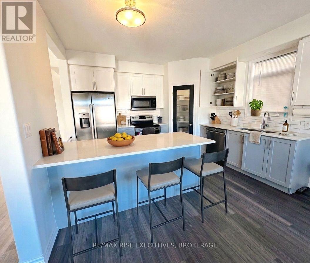 A kitchen with a table and chairs in the foreground.