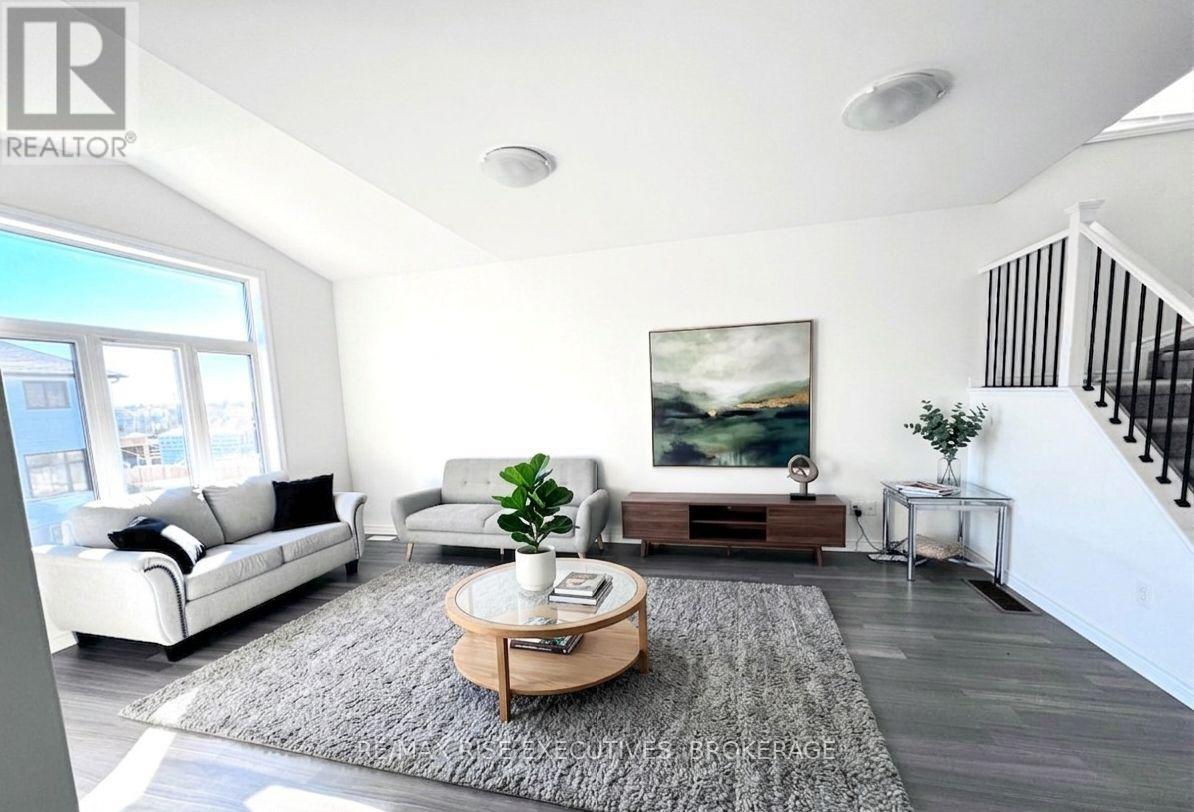 A living room with a white couch, a coffee table, and a painting on the wall.