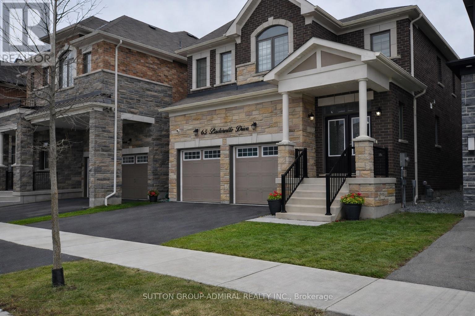 A house with a sign that says "Sutton Group" in front of it.