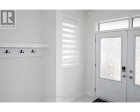 A white door with a glass window and a handle is in a room.