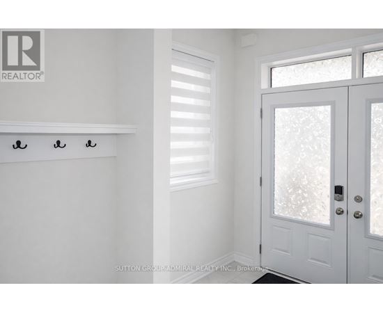 A white door with a glass window and a handle is in a room.