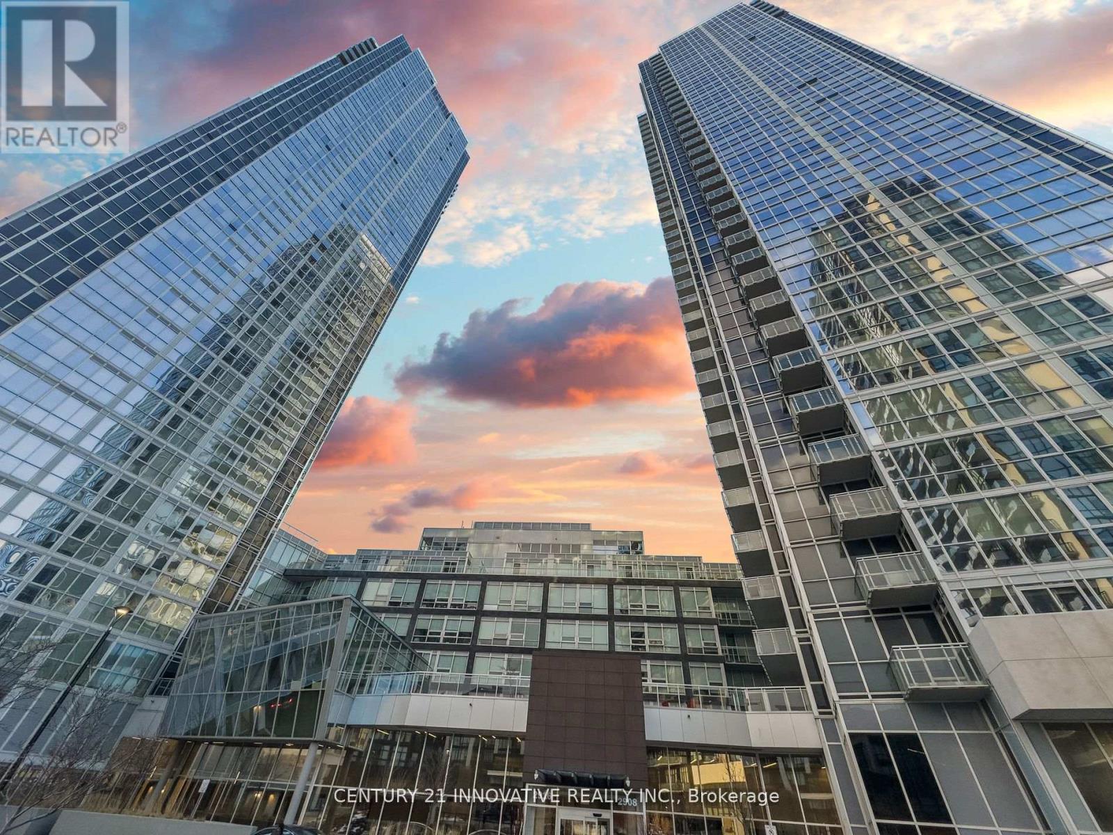 Two modern glass buildings with the logo "REALTOR" on the top left corner.