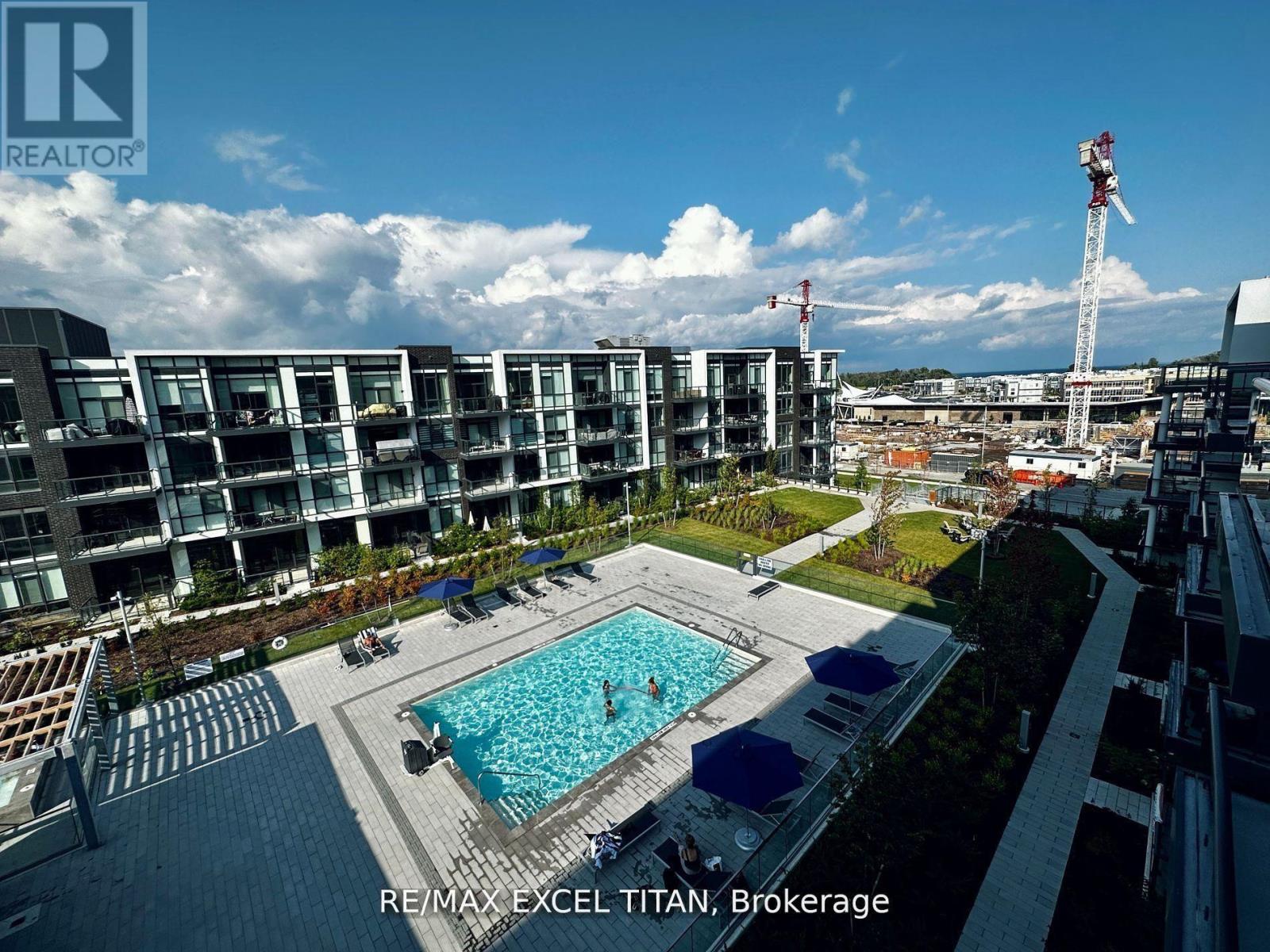 A large swimming pool is surrounded by apartment buildings in Brokerage.