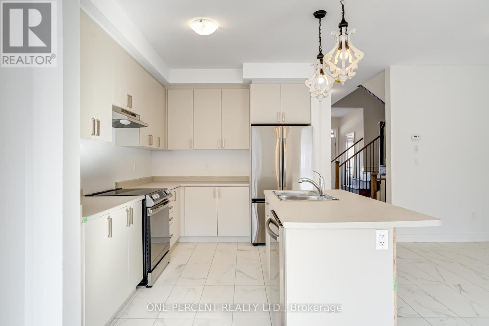 A kitchen with white cabinets and a black countertop.