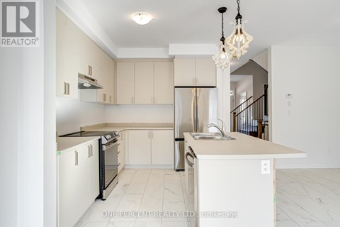 A kitchen with white cabinets and a black countertop.
