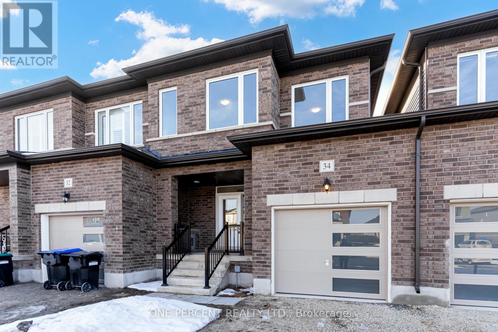 A brick house with a garage door and a sign that says "One Percent Realty, Brokerage.".