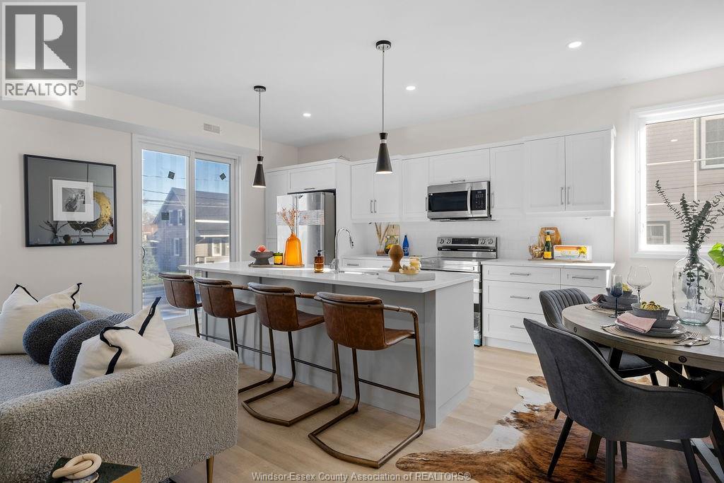 A modern kitchen with a dining table and chairs.