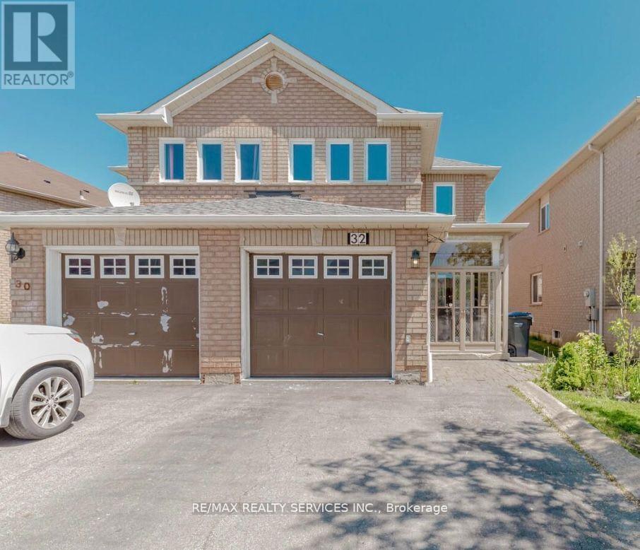 A house with a white car parked in front of it.