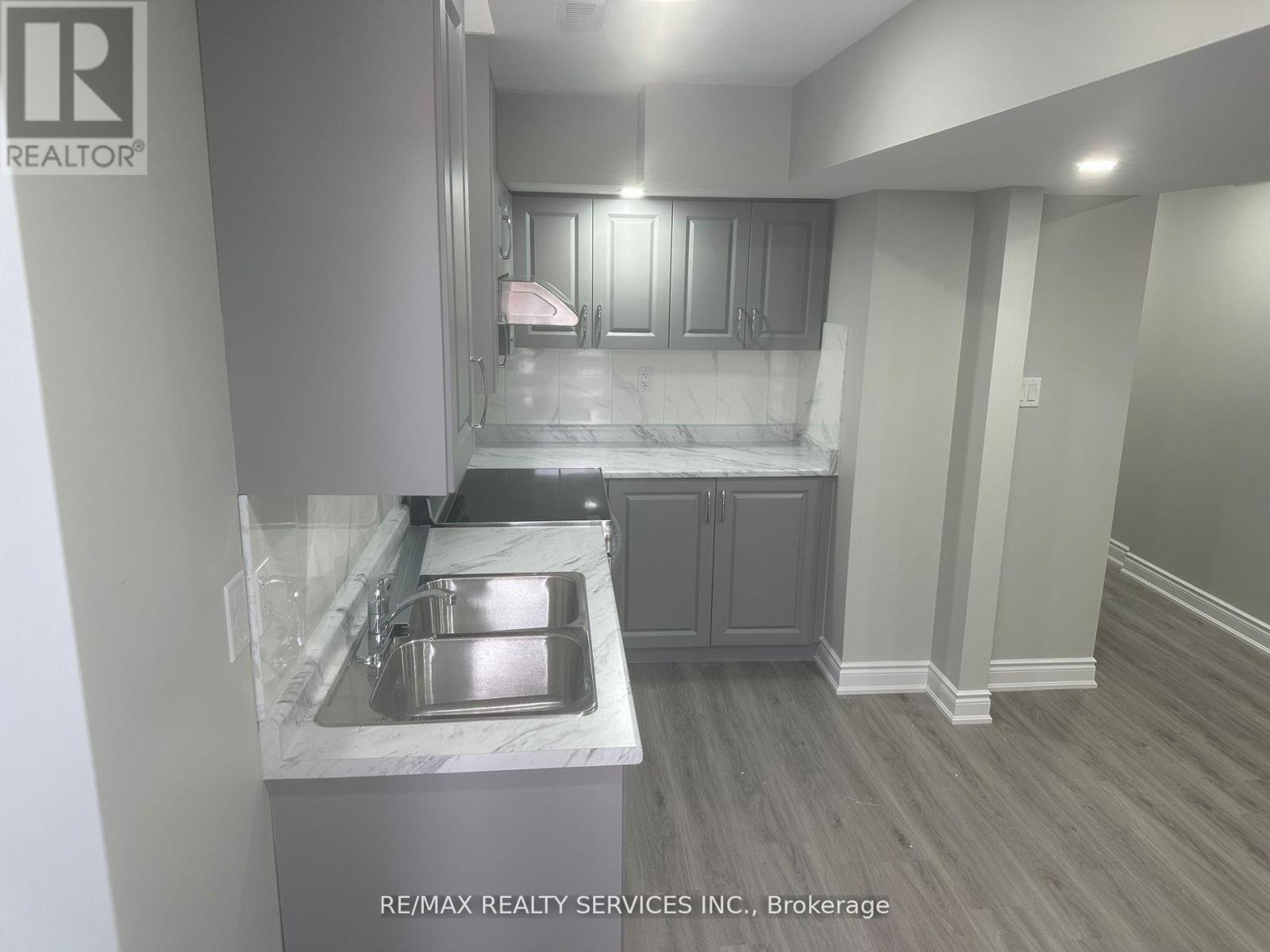 A kitchen with a sink and cabinets.