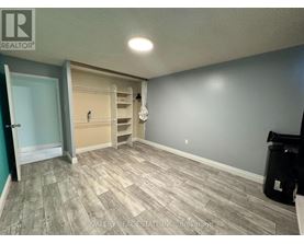 A room with a door and a wall with a shelf.
