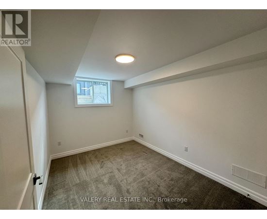 A room with a window and a door leading to another room.