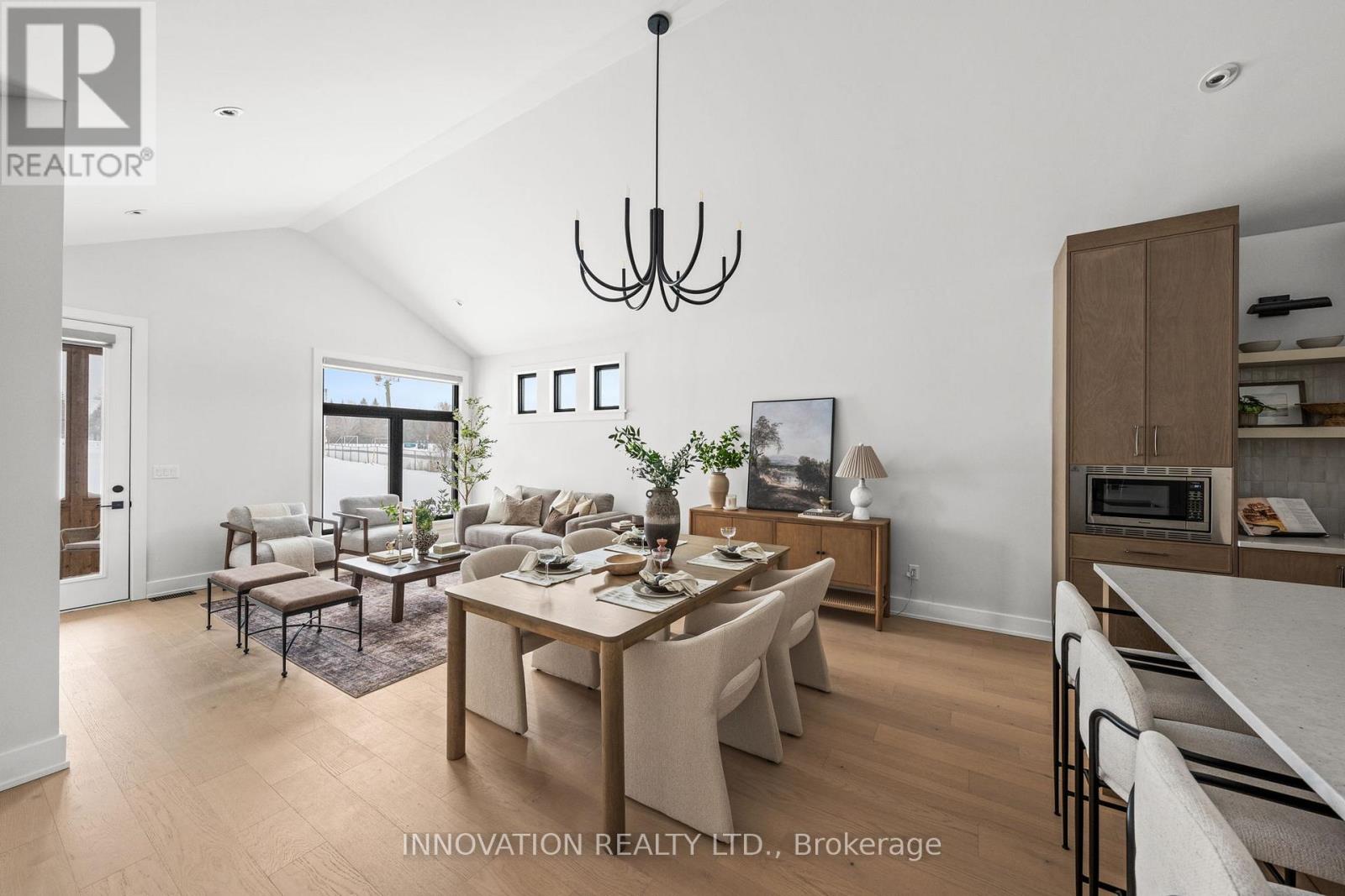 A modern dining room with a large table and chairs.