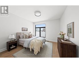 A bedroom with a bed, nightstand, and lamp.