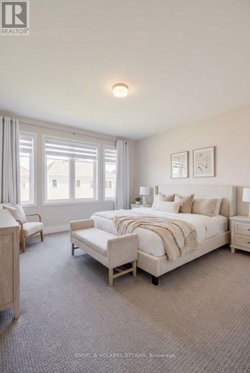 A bedroom with a large bed and a window with curtains.