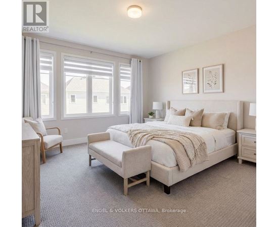 A bedroom with a large bed and a window with curtains.