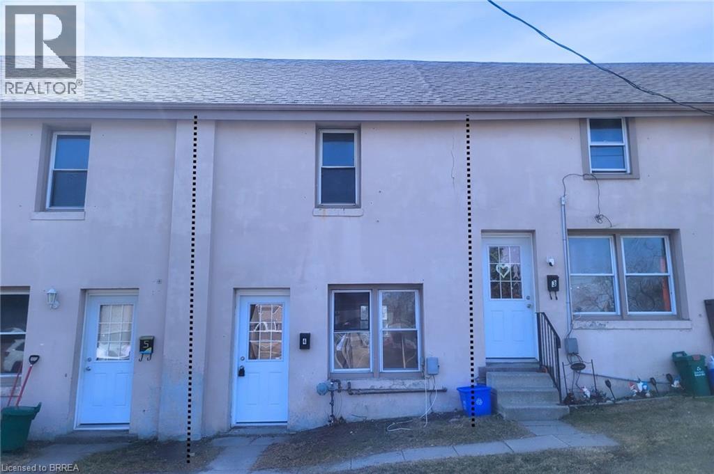 A house with a blue door and windows is for sale.