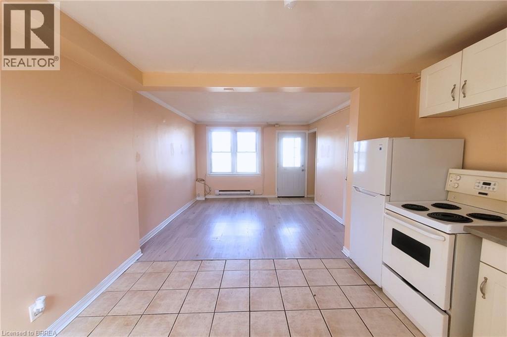 A kitchen with white appliances and cabinets is shown.