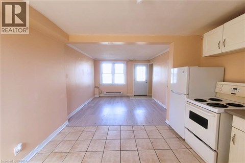 A kitchen with white appliances and cabinets is shown.