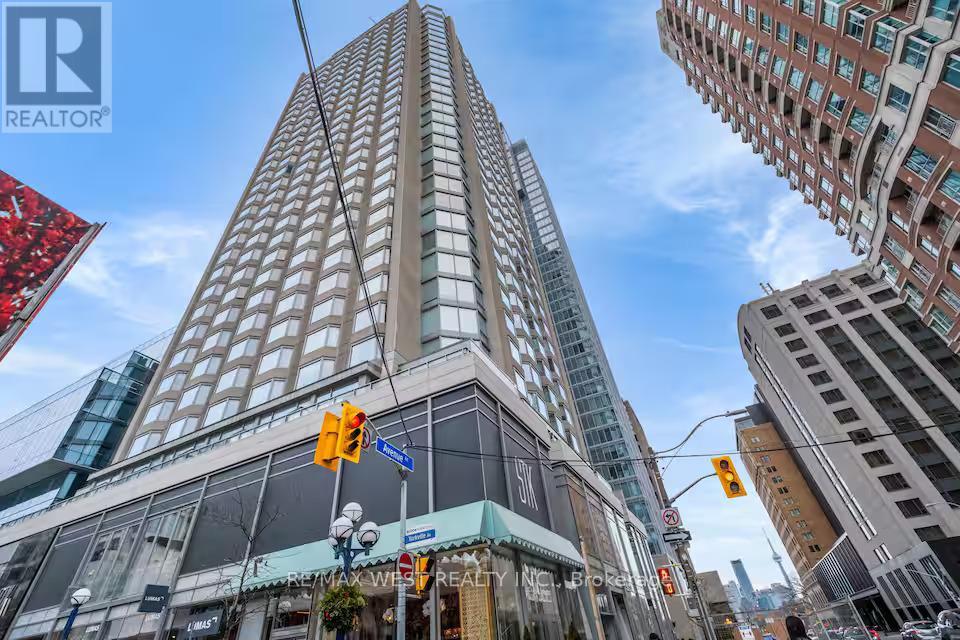 A tall building with a sign that says REALTOR in the foreground.