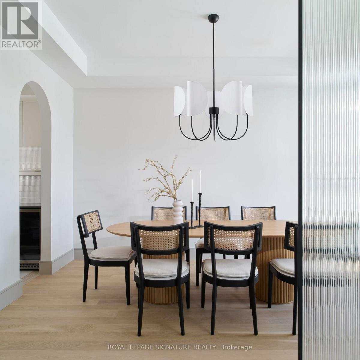A dining room with a table set for four.