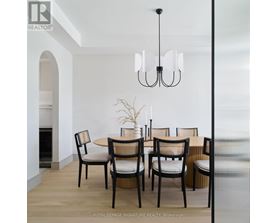 A dining room with a table set for four.