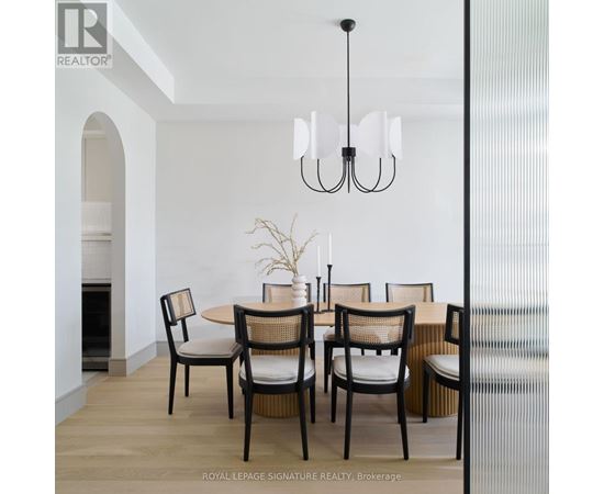 A dining room with a table set for four.