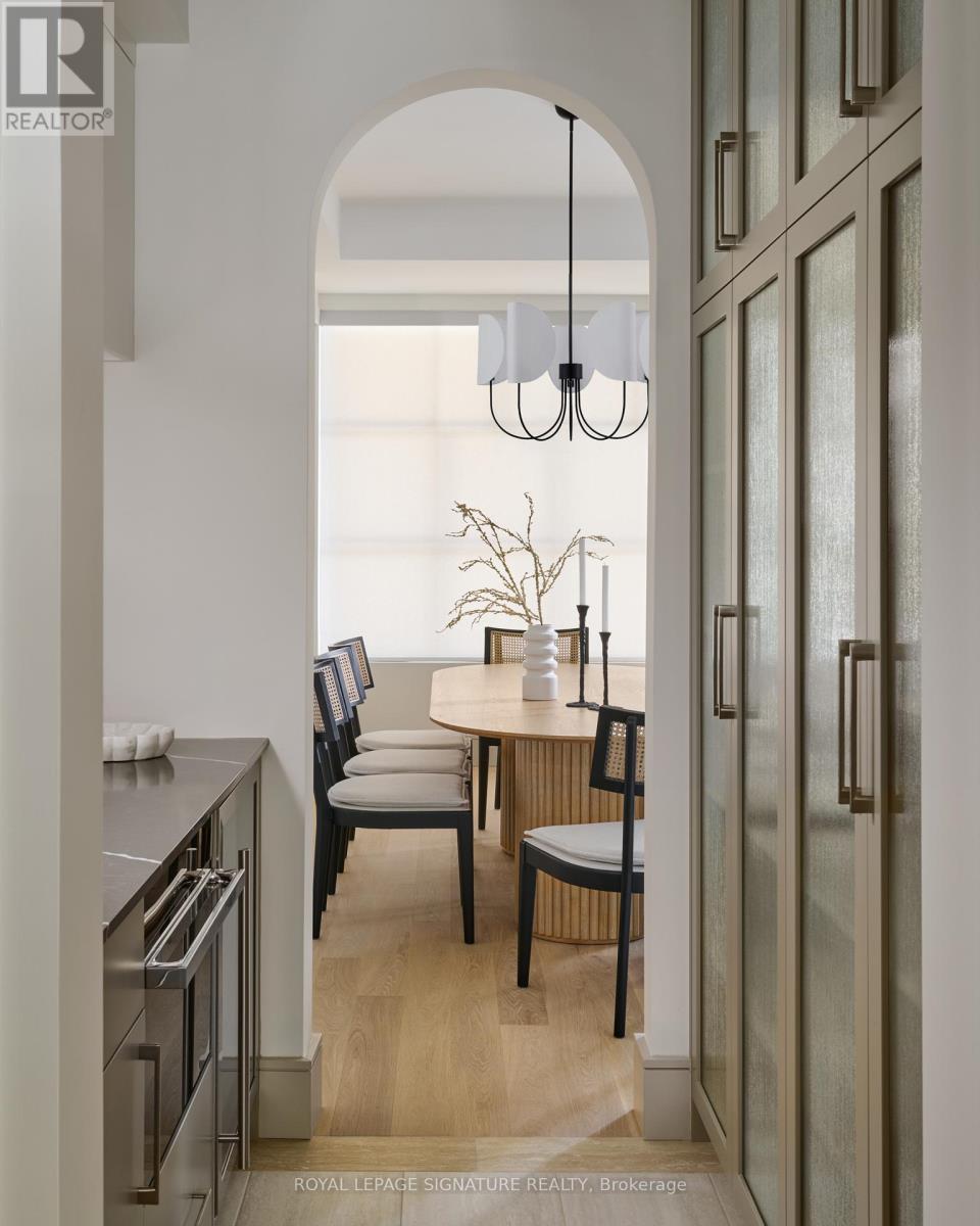 A modern kitchen with a dining table and chairs.