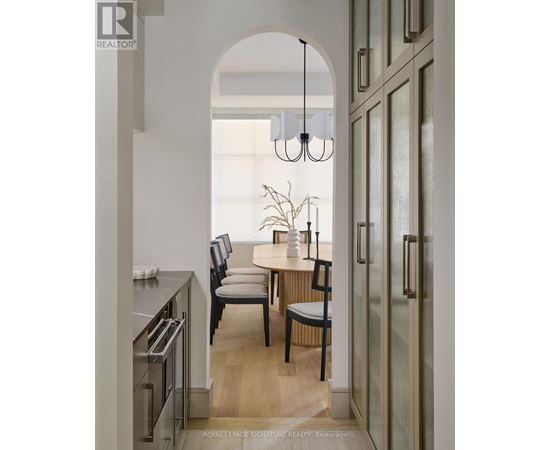 A modern kitchen with a dining table and chairs.