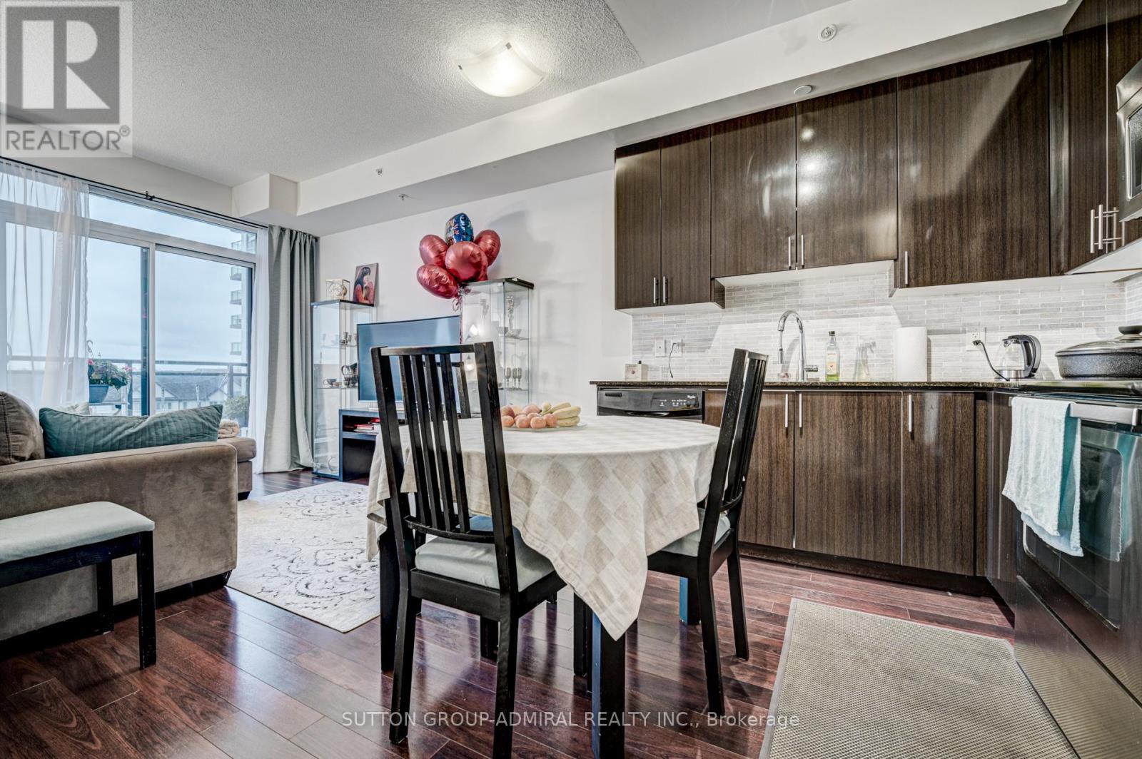A kitchen with a table and chairs in the middle of the room.