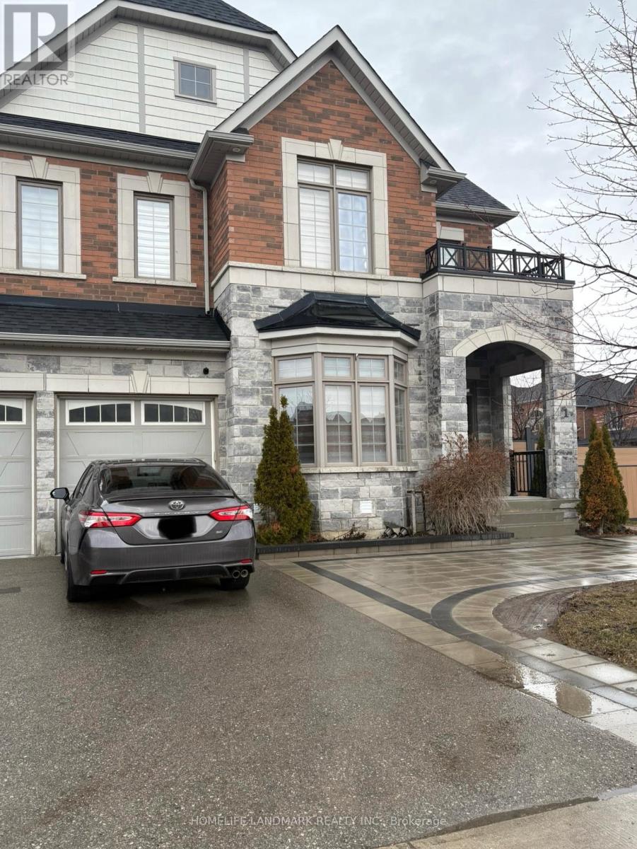 A black car is parked in front of a two-story house.