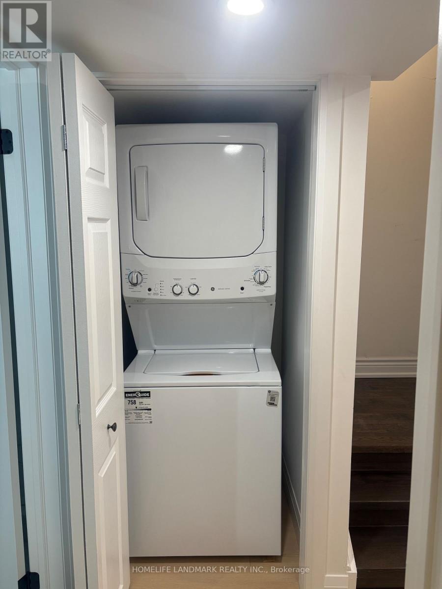 A white dishwasher is in a small space between a door and a wall.