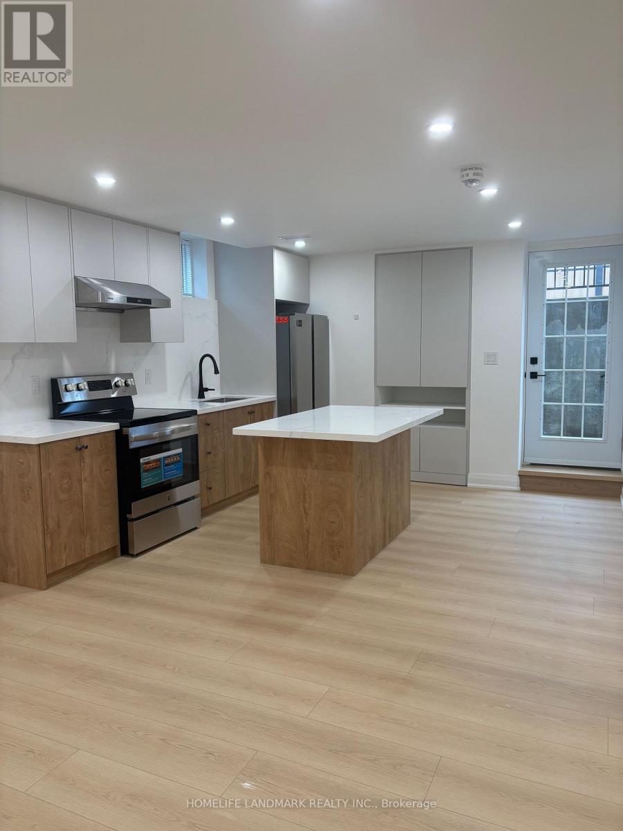 A modern kitchen with wooden cabinets and a central island.