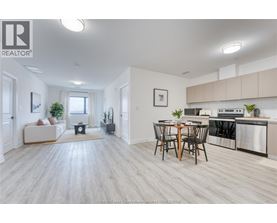 A well-lit, spacious kitchen and dining area with modern appliances and furniture.