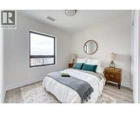 A bedroom with a bed, nightstand, and window.