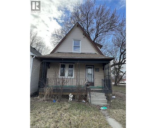 A house with a porch and a small yard.